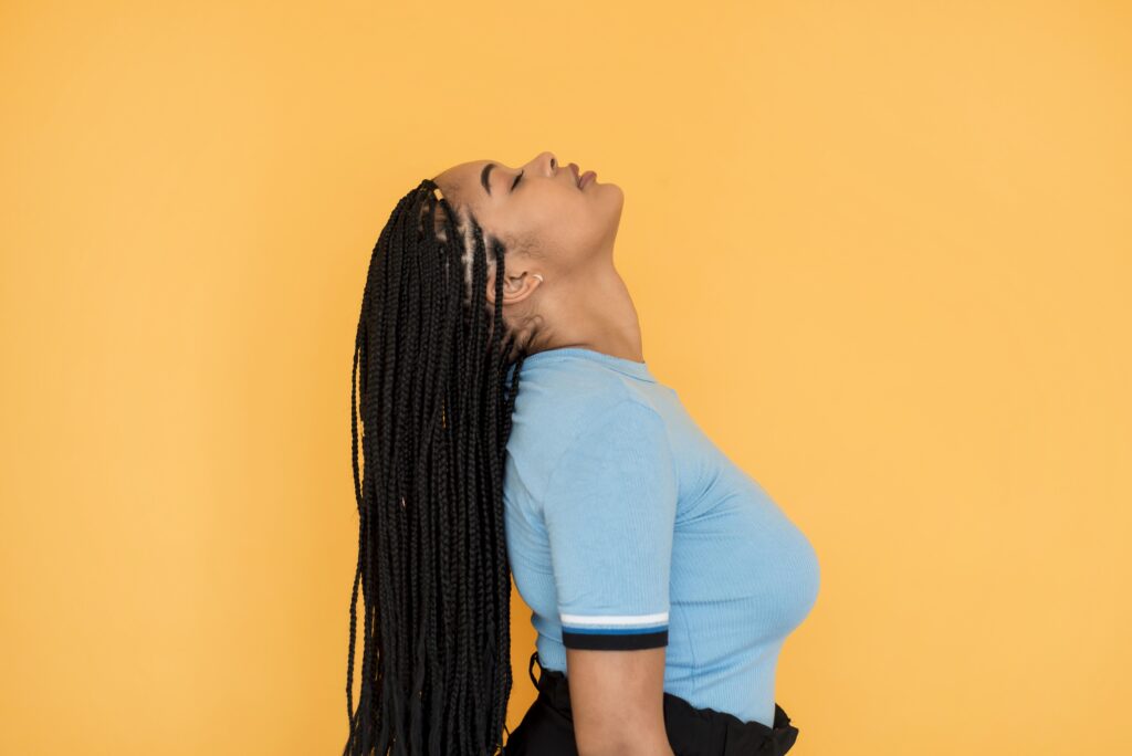 Knotless braids protective hairstyle for women, trending braiding styles in Houston