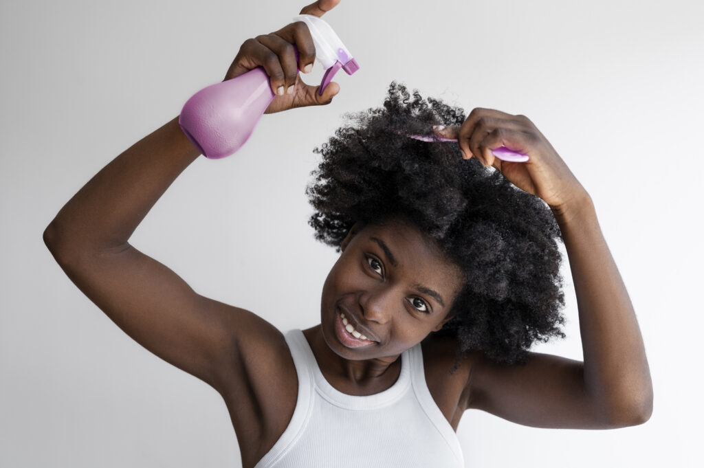Woman moisturizing scalp to maintain braids, part of braids maintenance Houston
